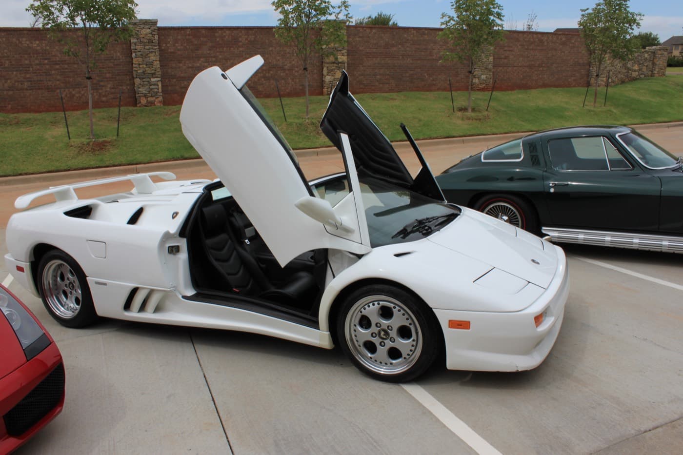White Lamborghini Diablo VT Roadster with scissor doors up after a detail